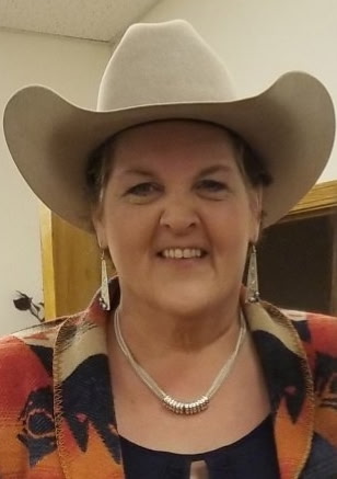 Angels Without Wings owner Nelseena Lehmann in a cowboy hat and tasteful cowgirl jewelry.